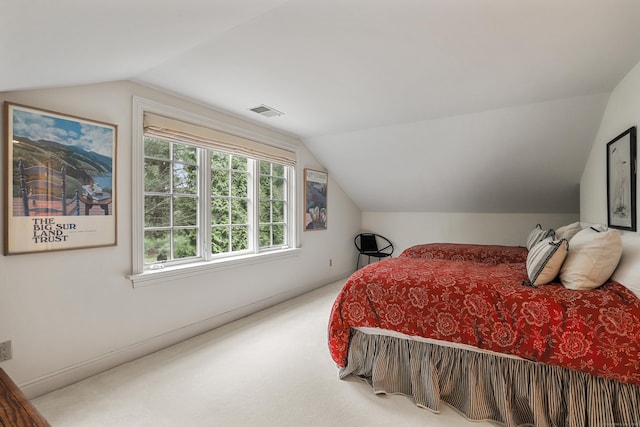 carpeted bedroom with visible vents and lofted ceiling