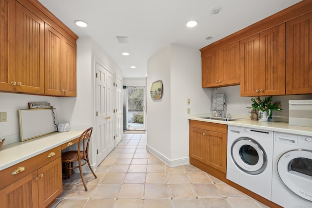 clothes washing area with a sink, baseboards, recessed lighting, and washing machine and dryer