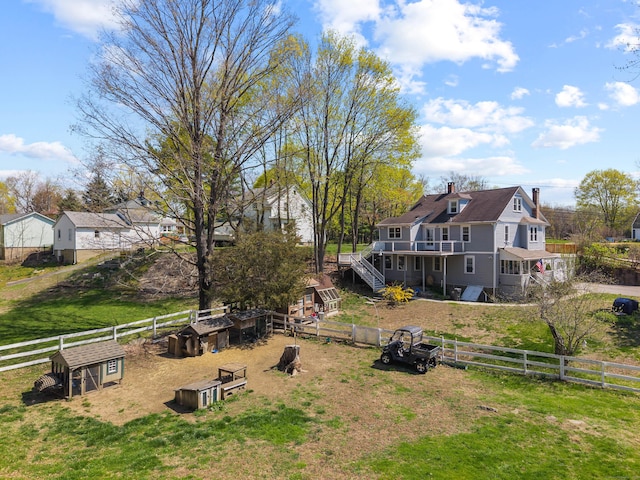 view of yard with a wooden deck, stairs, and fence