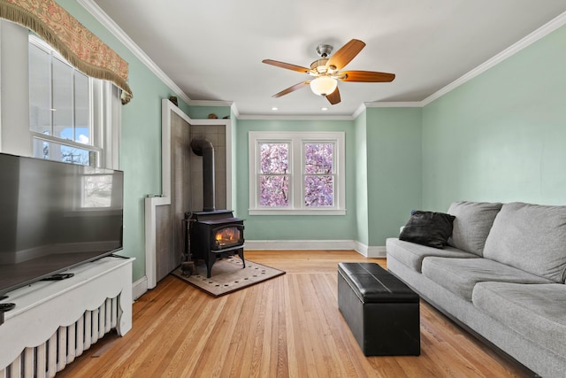 living room featuring baseboards, a ceiling fan, and plenty of natural light