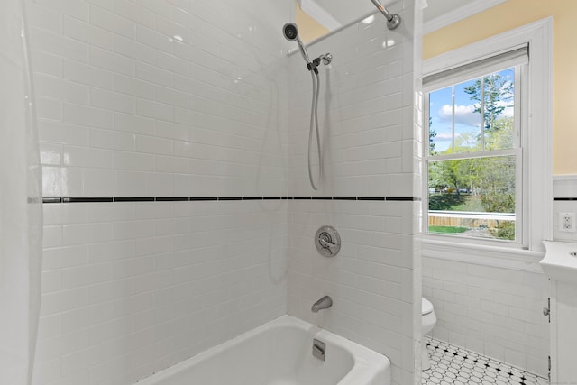 full bath featuring toilet, tile patterned flooring, bathtub / shower combination, and tile walls