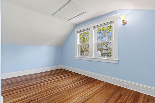 bonus room with vaulted ceiling, wood finished floors, and baseboards