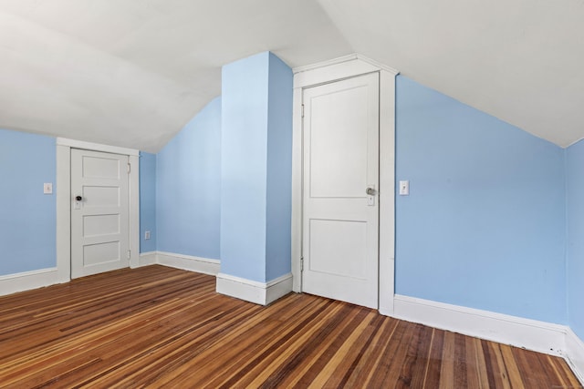 bonus room with lofted ceiling, wood finished floors, and baseboards