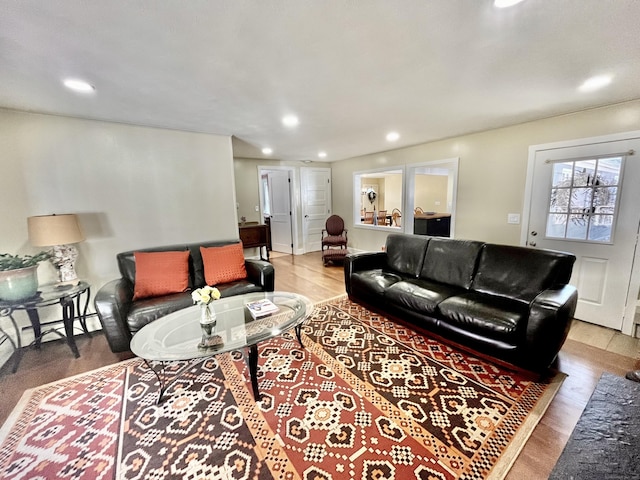 living area with recessed lighting and wood finished floors