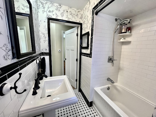 full bath with shower / tub combination, tile walls, wallpapered walls, and a wainscoted wall