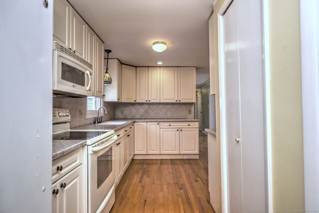 137 Harding Ave, West Haven, CT 06516 - kitchen with white appliances, a sink, dark wood-style floors, decorative backsplash, and white cabinets