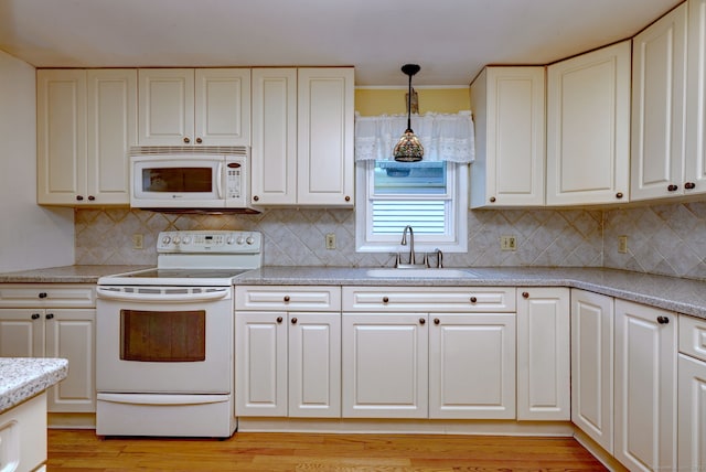 137 Harding Ave, West Haven, CT 06516 - kitchen with white appliances, a sink, white cabinetry, hanging light fixtures, and light countertops