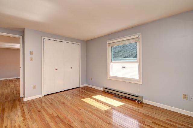 137 Harding Ave, West Haven, CT 06516 - unfurnished bedroom with light wood finished floors, a baseboard radiator, baseboards, and a closet