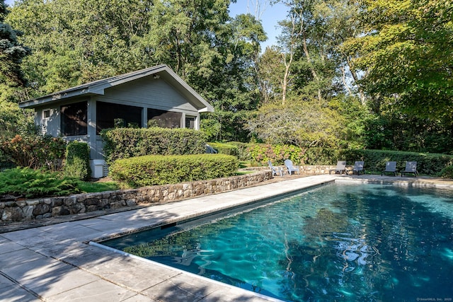 outdoor pool with a patio area