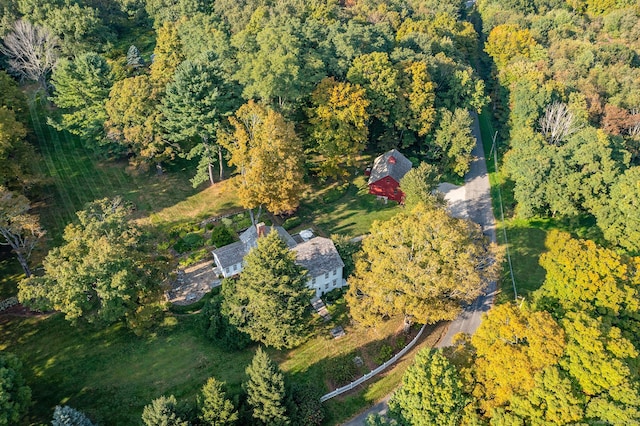 drone / aerial view with a wooded view