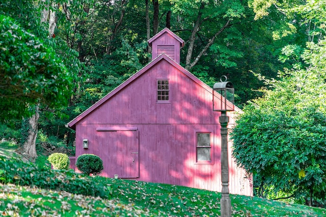 view of barn with a view of trees