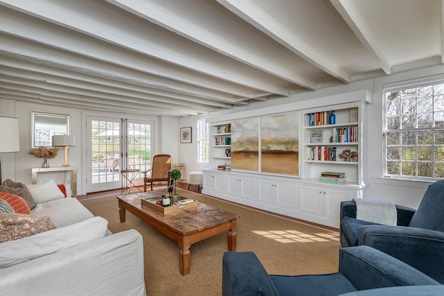 carpeted living room featuring beamed ceiling