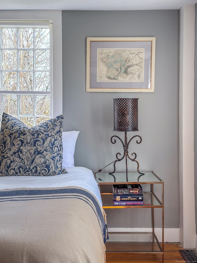 bedroom featuring baseboards and wood finished floors