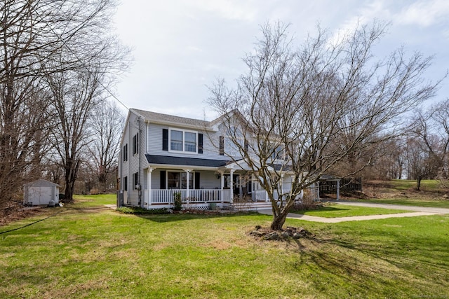 269 Silver Hill Rd, Derby, CT 06418 - view of front of home featuring concrete driveway, a front lawn, a shed, a porch, and an outbuilding