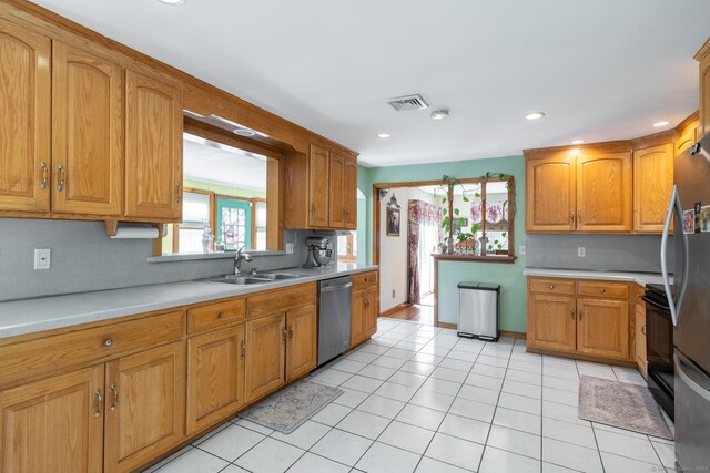 269 Silver Hill Rd, Derby, CT 06418 - kitchen with brown cabinetry, visible vents, light countertops, a sink, and stainless steel appliances