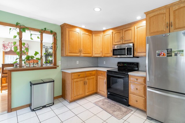 269 Silver Hill Rd, Derby, CT 06418 - kitchen with light tile patterned flooring, recessed lighting, light countertops, and stainless steel appliances