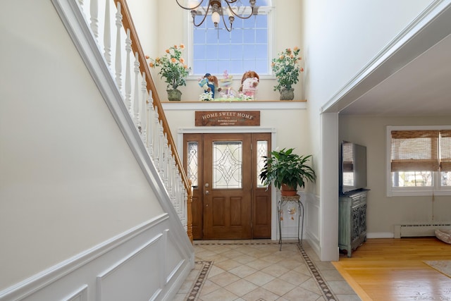 269 Silver Hill Rd, Derby, CT 06418 - foyer entrance with a high ceiling, stairway, a notable chandelier, and baseboard heating