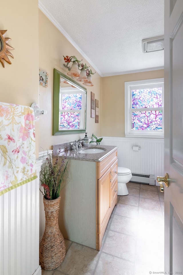 269 Silver Hill Rd, Derby, CT 06418 - bathroom with a textured ceiling, vanity, a wainscoted wall, toilet, and a baseboard heating unit