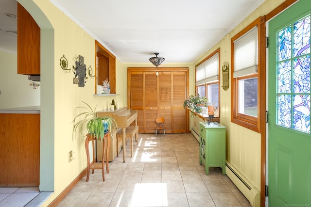 269 Silver Hill Rd, Derby, CT 06418 - interior space featuring arched walkways, light tile patterned floors, baseboard heating, and ornamental molding