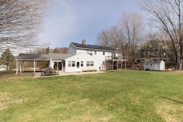 269 Silver Hill Rd, Derby, CT 06418 - back of house featuring an outbuilding, a yard, a patio, and a chimney