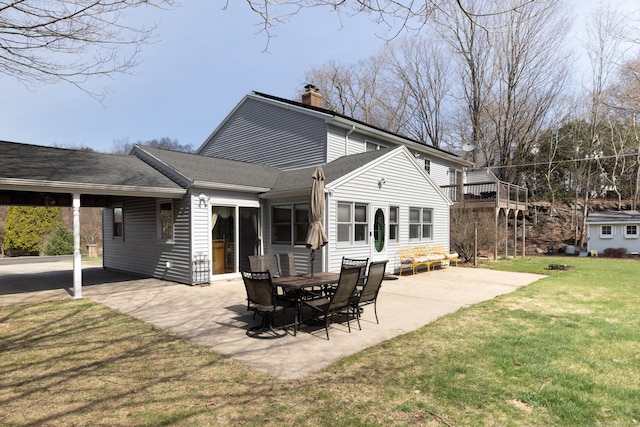269 Silver Hill Rd, Derby, CT 06418 - rear view of property featuring a yard, a patio, a chimney, a shingled roof, and an attached carport