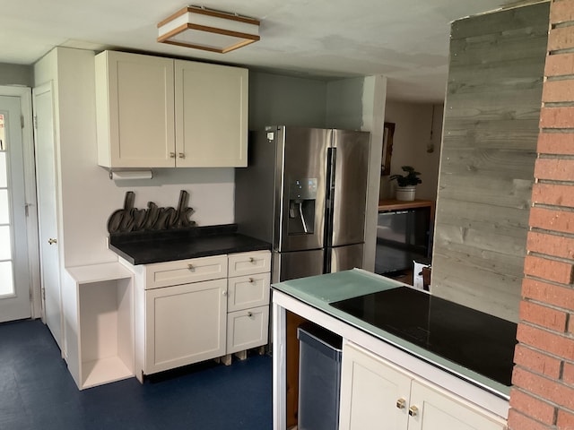 kitchen featuring stainless steel fridge, dark countertops, white cabinetry, and wine cooler
