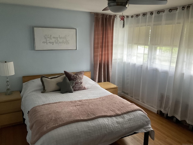 bedroom featuring wood finished floors and a ceiling fan