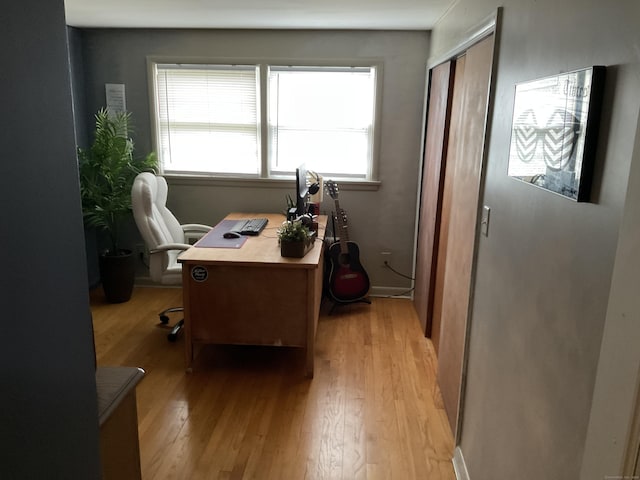 home office with light wood finished floors