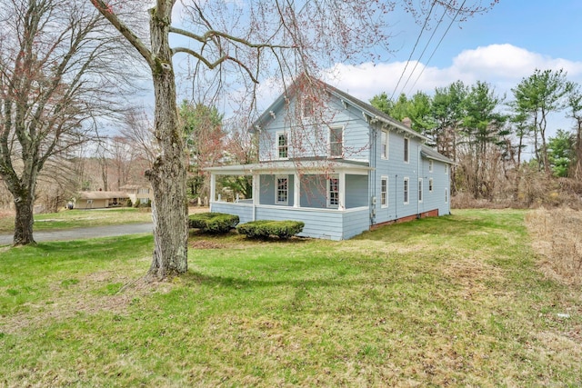 view of side of home featuring a lawn