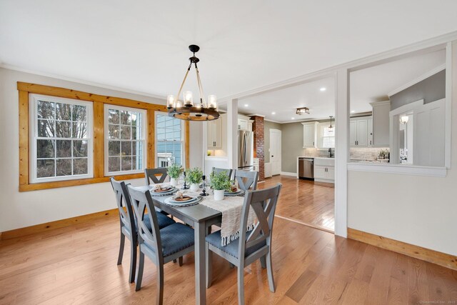 dining area with recessed lighting, a healthy amount of sunlight, a chandelier, and light wood-type flooring