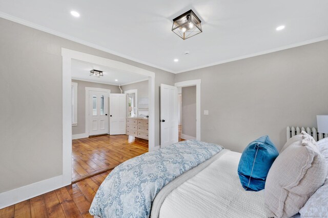bedroom featuring recessed lighting, hardwood / wood-style floors, and baseboards