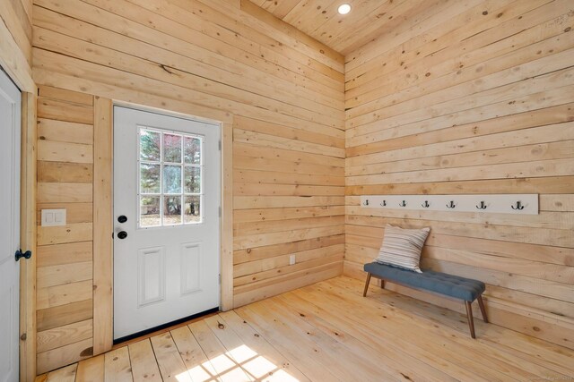 doorway to outside with wooden walls, recessed lighting, hardwood / wood-style floors, and wooden ceiling