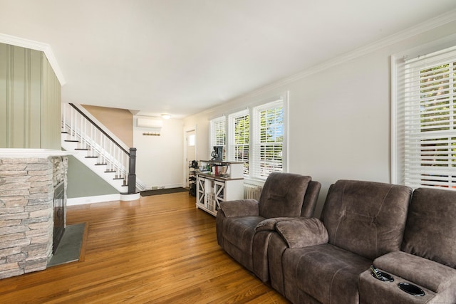 37 Dale Rd, Wethersfield, CT 06109 - living area featuring wood finished floors, stairs, ornamental molding, radiator heating unit, and a wall mounted AC