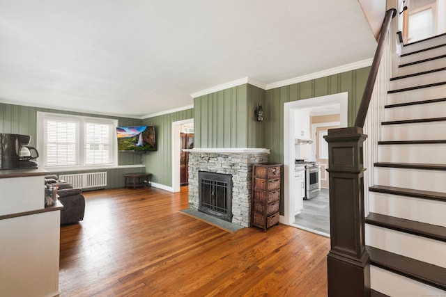 37 Dale Rd, Wethersfield, CT 06109 - living area with radiator heating unit, stairway, crown molding, hardwood / wood-style flooring, and a fireplace