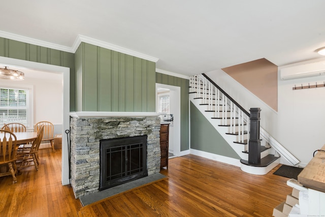 37 Dale Rd, Wethersfield, CT 06109 - living room with stairs, a wall mounted air conditioner, wood finished floors, ornamental molding, and plenty of natural light