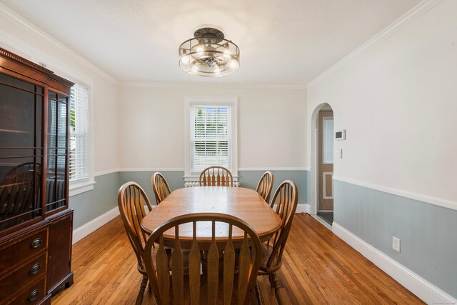 37 Dale Rd, Wethersfield, CT 06109 - dining space featuring arched walkways, light wood-type flooring, crown molding, and a chandelier
