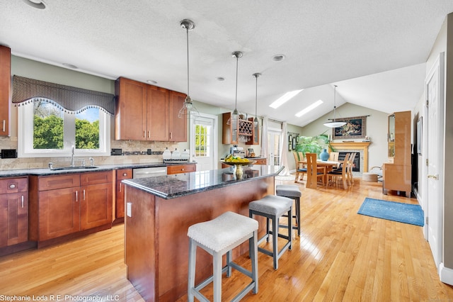 38 Benjamin Rd, East Haven, CT 06513 - kitchen with a breakfast bar area, a center island, a sink, and light wood-style floors