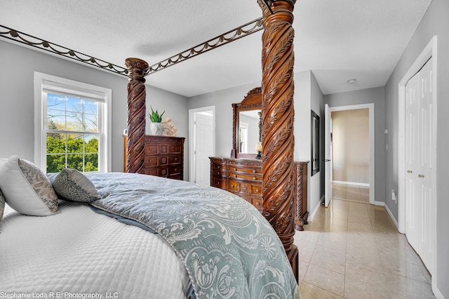 38 Benjamin Rd, East Haven, CT 06513 - bedroom with light tile patterned flooring, a textured ceiling, baseboards, and a closet