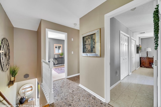 38 Benjamin Rd, East Haven, CT 06513 - hallway with baseboards, an upstairs landing, and visible vents