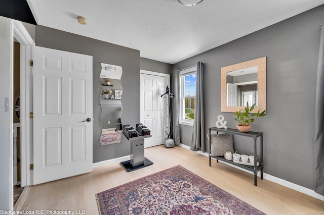 38 Benjamin Rd, East Haven, CT 06513 - entryway featuring a textured ceiling, baseboards, and light wood-type flooring