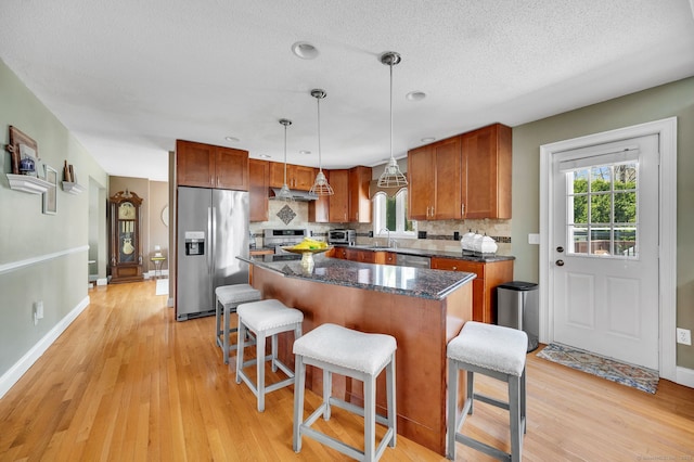 38 Benjamin Rd, East Haven, CT 06513 - kitchen featuring light wood-style floors, decorative backsplash, a wealth of natural light, and stainless steel appliances