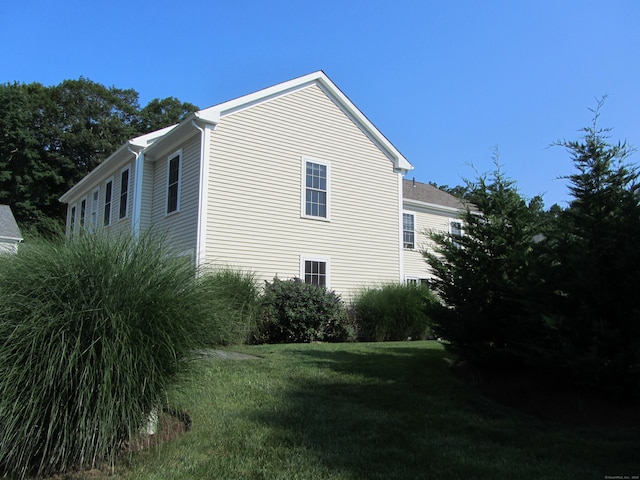view of home's exterior featuring a yard