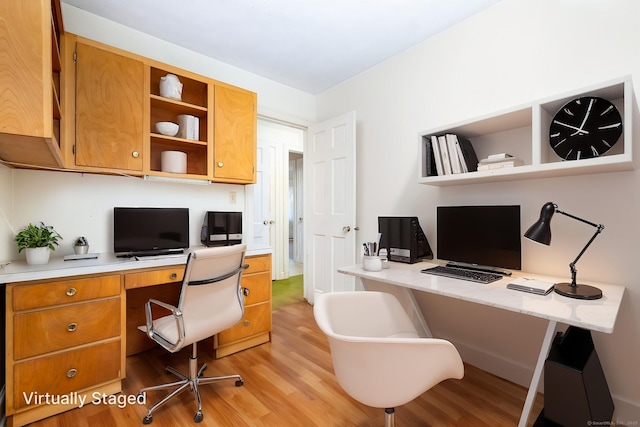 office featuring light wood-style flooring and built in desk