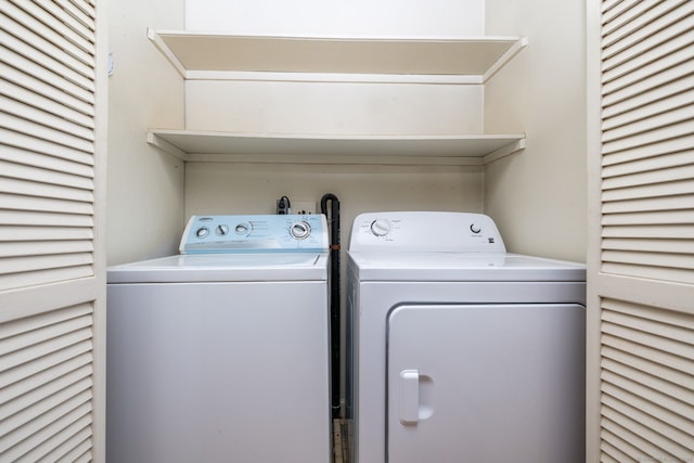 laundry room featuring washing machine and clothes dryer and laundry area