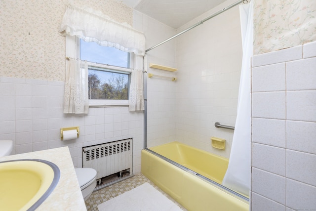 bathroom with toilet, shower / bath combo with shower curtain, radiator, wallpapered walls, and tile walls