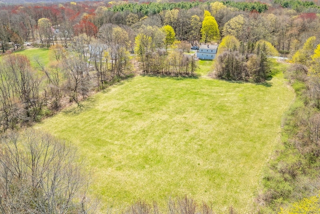 drone / aerial view with a wooded view