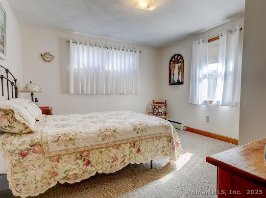 67 Stuart St, Newington, CT 06111 - bedroom with multiple windows, baseboards, carpet, and a baseboard heating unit