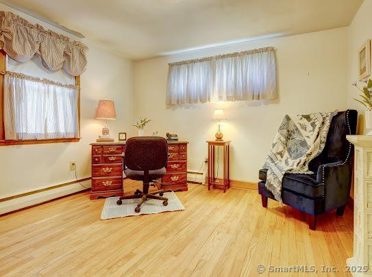 67 Stuart St, Newington, CT 06111 - home office with wood finished floors, baseboards, and a baseboard heating unit