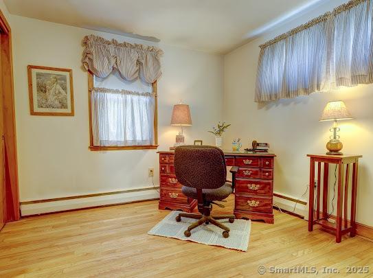 67 Stuart St, Newington, CT 06111 - office with baseboard heating, wood finished floors, baseboards, and a baseboard radiator