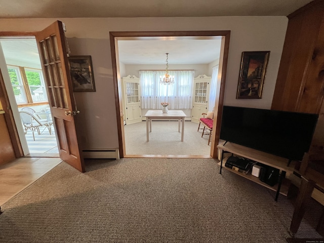 67 Stuart St, Newington, CT 06111 - corridor with healthy amount of natural light, a chandelier, a baseboard radiator, and wood finished floors